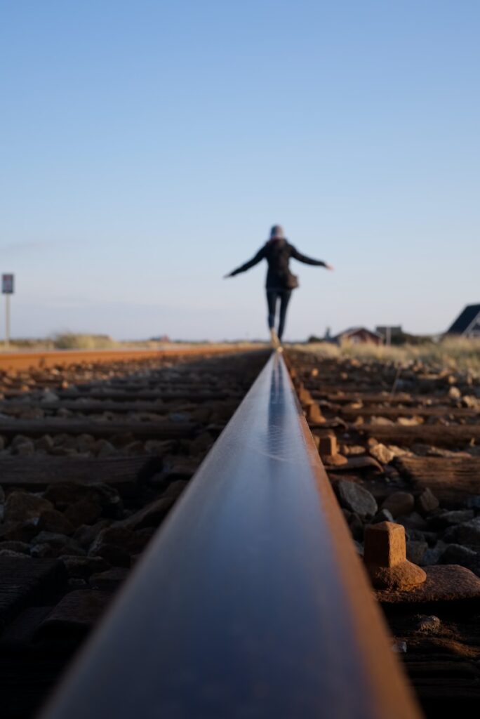 woman walking on train railway running with knee pain