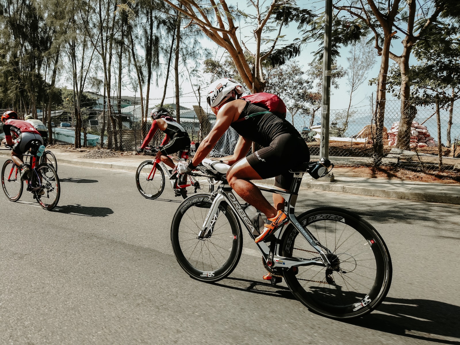 three cyclists on road Ironman training