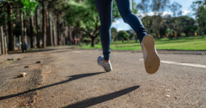 Photo of feet and legs of person running in the park